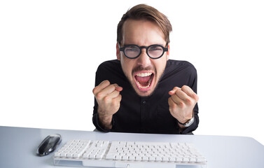 Businessman cheering in front of his computer