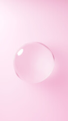 ピンクの背景に浮かぶ水の球体。球体のガラス。（縦長）