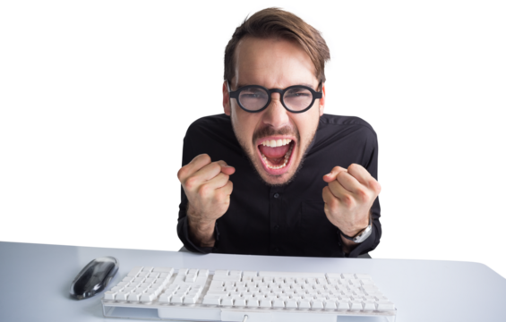 Businessman cheering in front of his computer