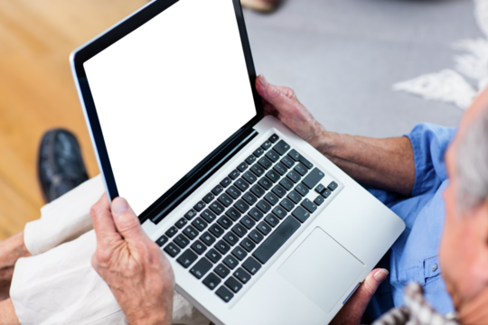 Senior couple holding laptop - Powered by Adobe