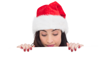 Pretty brunette in santa hat showing white poster