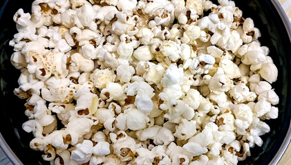 A closeup view of bowl of popcorn on a wooden table