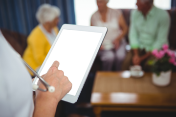 Cropped image of doctor using digital tablet