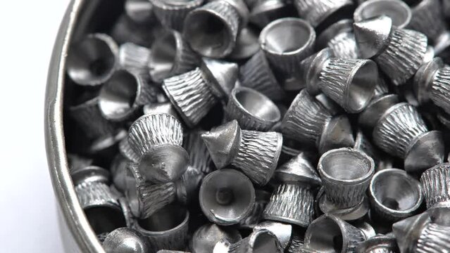 A pack full of sharp metal diabolo pellets, steel pellet air gun ammo, lots of pneumatic gun ammunition, gas weapons abstract concept. Group of objects macro, detail, extreme closeup, nobody no people