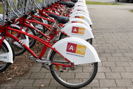 ANTWERP, BELGIUM, 11 MARCH 2023: A row of share bikes at a bike station in Antwerp. Velo is the first and biggest bike share company in Antwerp and surrounding districts. Copy space on right.