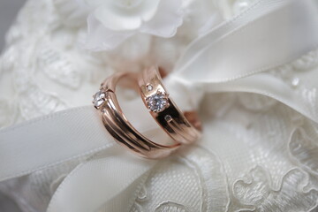 Pair of rose gold wedding rings with diamond