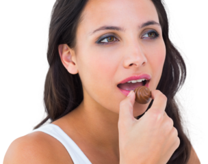 Pretty brunette eating chocolate candy