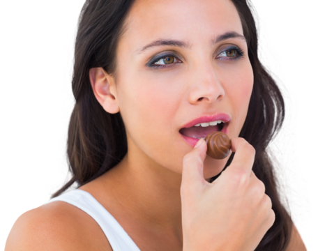 Pretty brunette eating chocolate candy