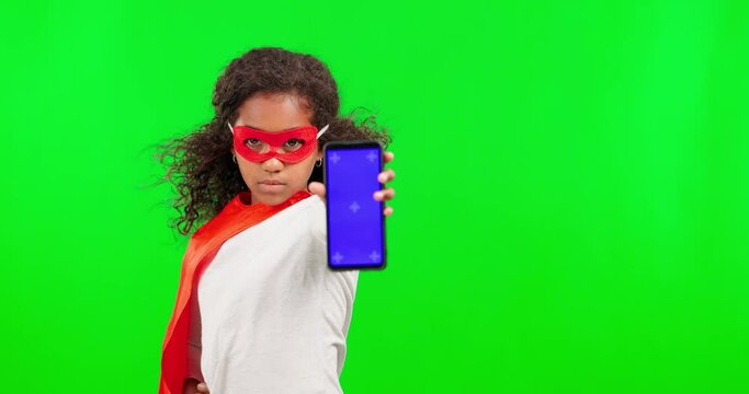 Girl child, superhero and phone by green screen for crime, justice and mockup with tracking markers ux. Female kid, super hero and smartphone with mock up space with costume, vigilante and games