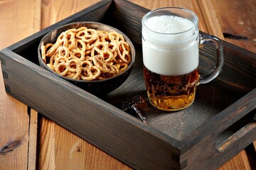 beer with pretzels in a rustic style