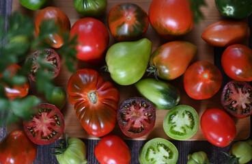 Fresh sliced tomatoes on black background, copy space