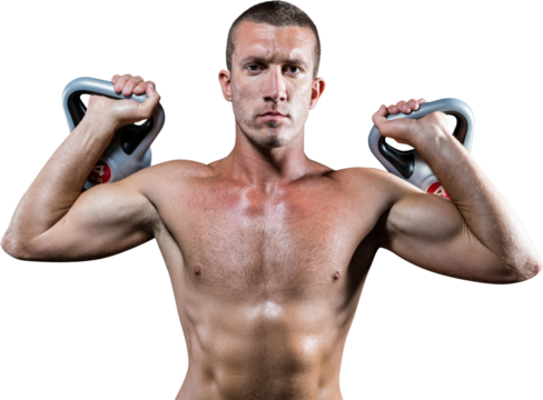 Confident shirtless athlete holding kettlebells