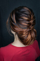 Naklejka premium Photo of a stylish female hairstyle, on the back of the girl's head. Image for your creative decoration or design.