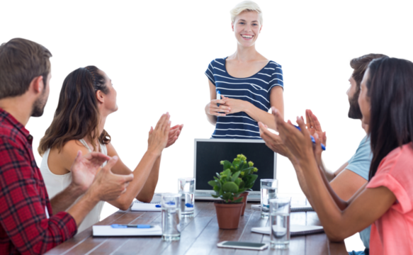 Colleagues clapping hands in a meeting
