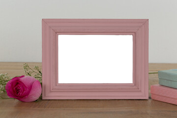 Fototapeta premium Photo frame, rose flower and gift boxes on a table