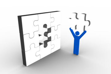 Blue man standing with white jigsaw piece by incomplete puzzle