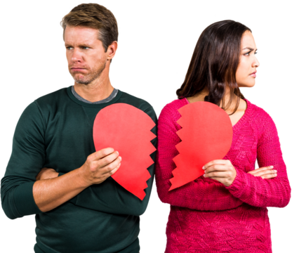 Serious couple holding cracked heart shape