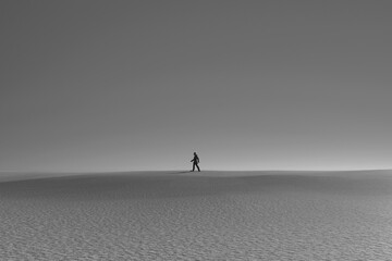 Silhouette of a person walking in the desert. 3d render