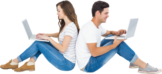 Happy couple sitting on floor back to back using laptop