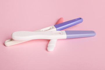 Rapid diagnosis of pregnancy at home. Pregnancy test kits with two bars on isolated pink pastel background. Copy ad space. Women's health, gynecology and medicine concept. Planning maternity concept