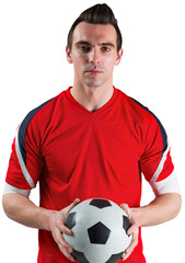 Handsome football fan looking at camera