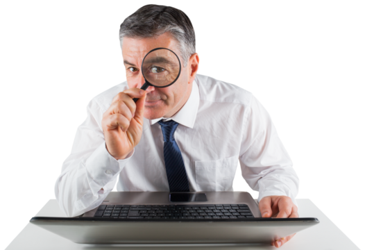 Mature businessman examining with magnifying glass