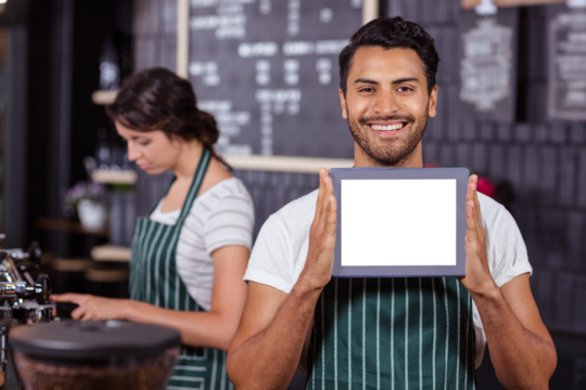 Man holding a tablet with a woman in background