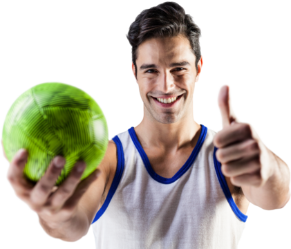Portrait of man showing thumbs up while holding ball