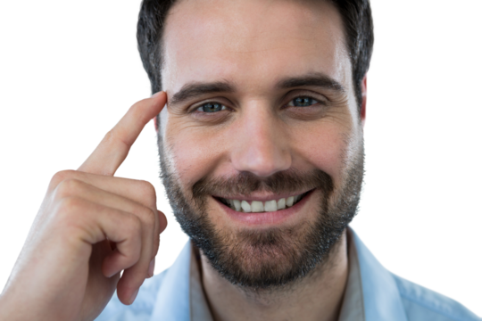 Smiling man with finger pointing to head