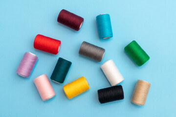 Randomly arranged colored spools of sewing thread close-up