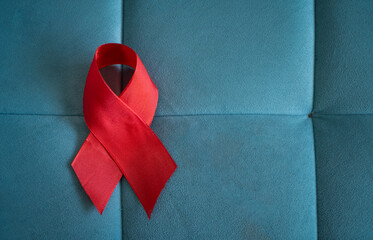 Stroke Awareness Month image, Red ribbon isolated on aqua colour background - Powered by Adobe