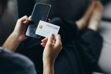 Close up of young woman holding credit card using smartphone online payment, home shopping, ecommerce, internet banking, spend money, finance, e-shop concept.