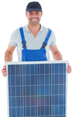 Smiling handyman in overalls carrying solar panel