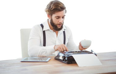 Hipster holding coffee working on typewriter