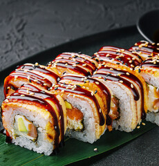 Sushi set canada roll with eel on black stone
