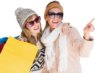 Beautiful women holding shopping bags pointing 