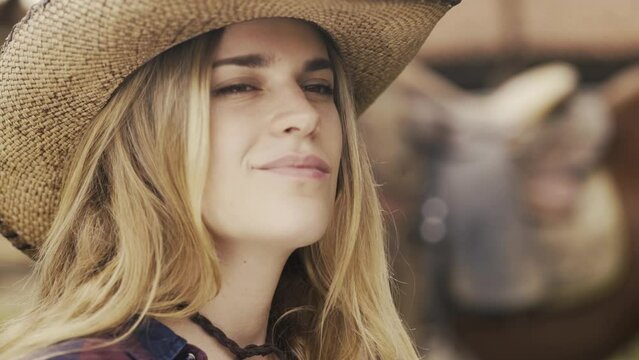 Cowgirl modeling and wearing a hat on a ranch-4K