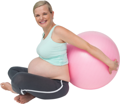 Pregnant woman leaning against pink exercise ball