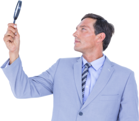 concentrated businessman using magnifying glass