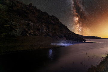 Beautiful night landscape. Bright Milky Way galaxy over the lake. 