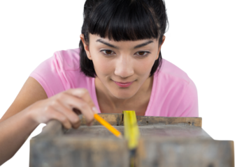 Woman measuring wooden plank with tape measure