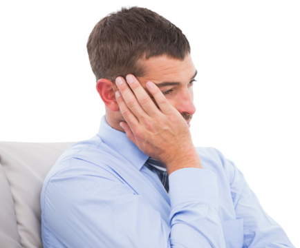 Upset businessman sitting on sofa