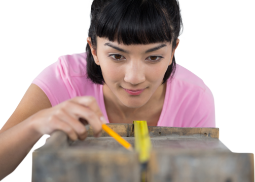 Woman measuring wooden plank with tape measure