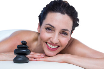 Smiling brunette relaxing on massage table
