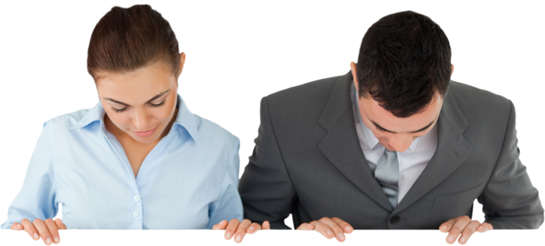 Business partners looking down at sign they are holding