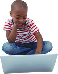 Boy sitting while using laptop