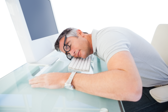 Businessman resting head on computer keyboard