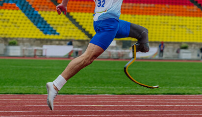 athlete runner sprinter on prosthesis running stadium track, disabled athlete para athletics...