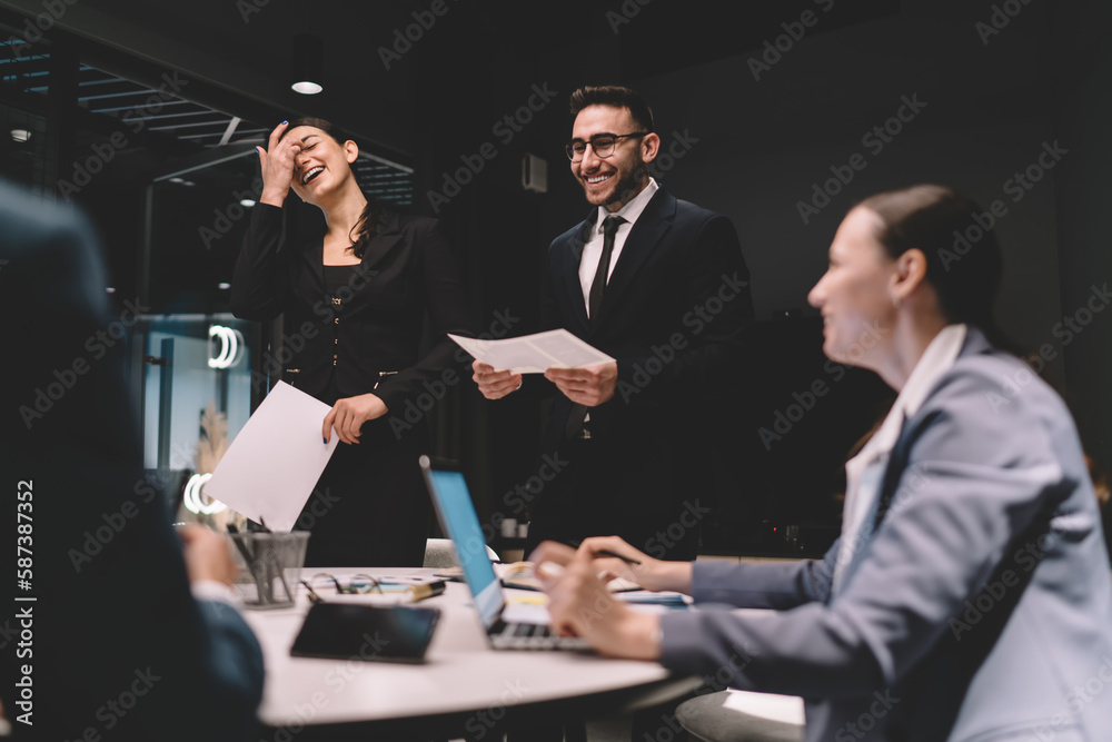 Wall mural cheerful colleagues discussing project in office