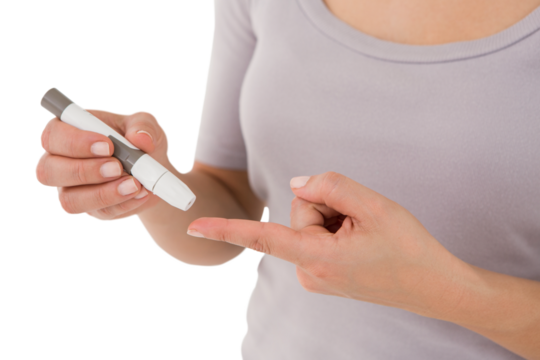 Diabetic woman using blood glucose monitor
